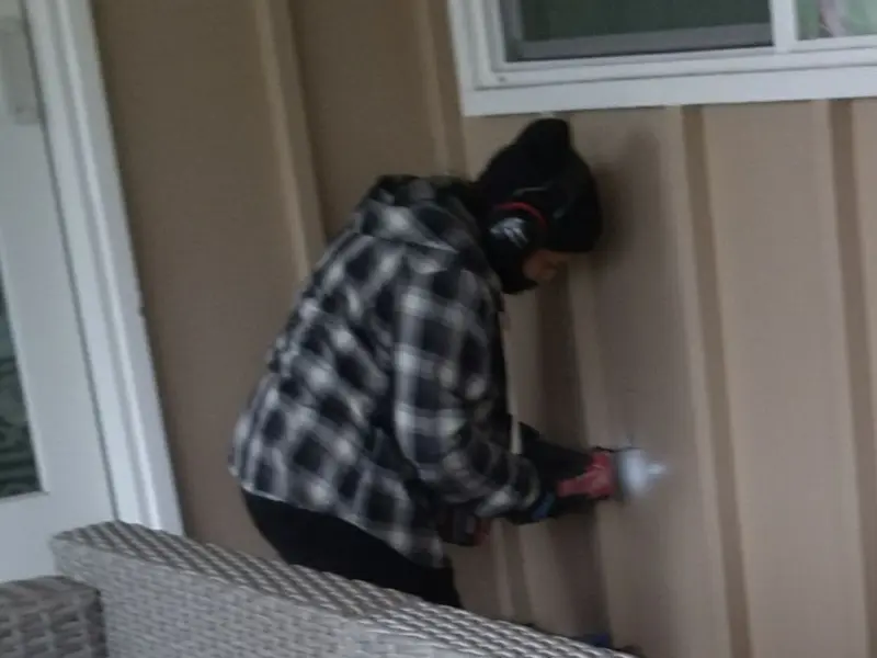 Professional electrician installing an exterior outlet in Aurelius